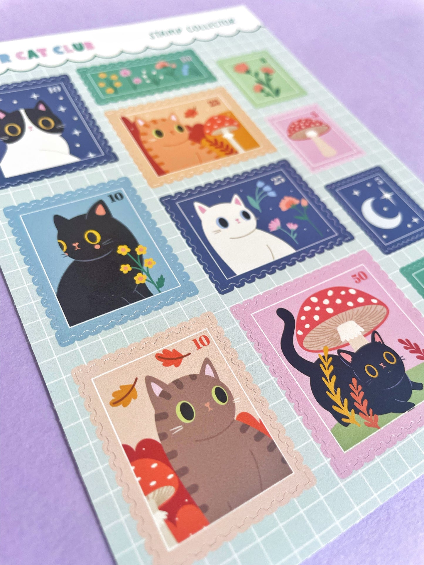Close-up of adorable cat stamp stickers on an A6 sheet, showcasing kawaii-style designs for journaling and planner decoration.