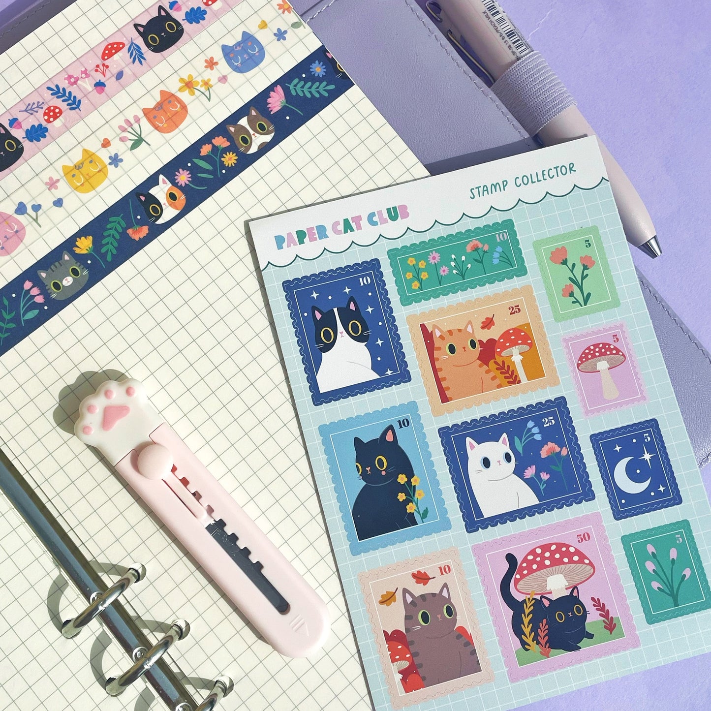 Close-up of adorable cat stamp stickers on an A6 sheet, showcasing kawaii-style designs for journaling and planner decoration.