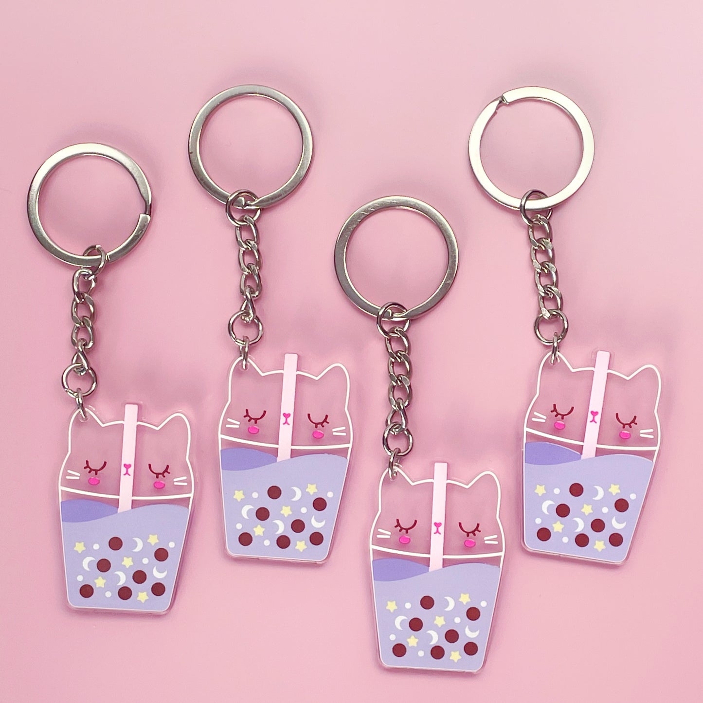 Kawaii lilac acrylic keychains featuring a double-sided design of a cute cat as bubble tea, perfect for cat lovers and kawaii fans.