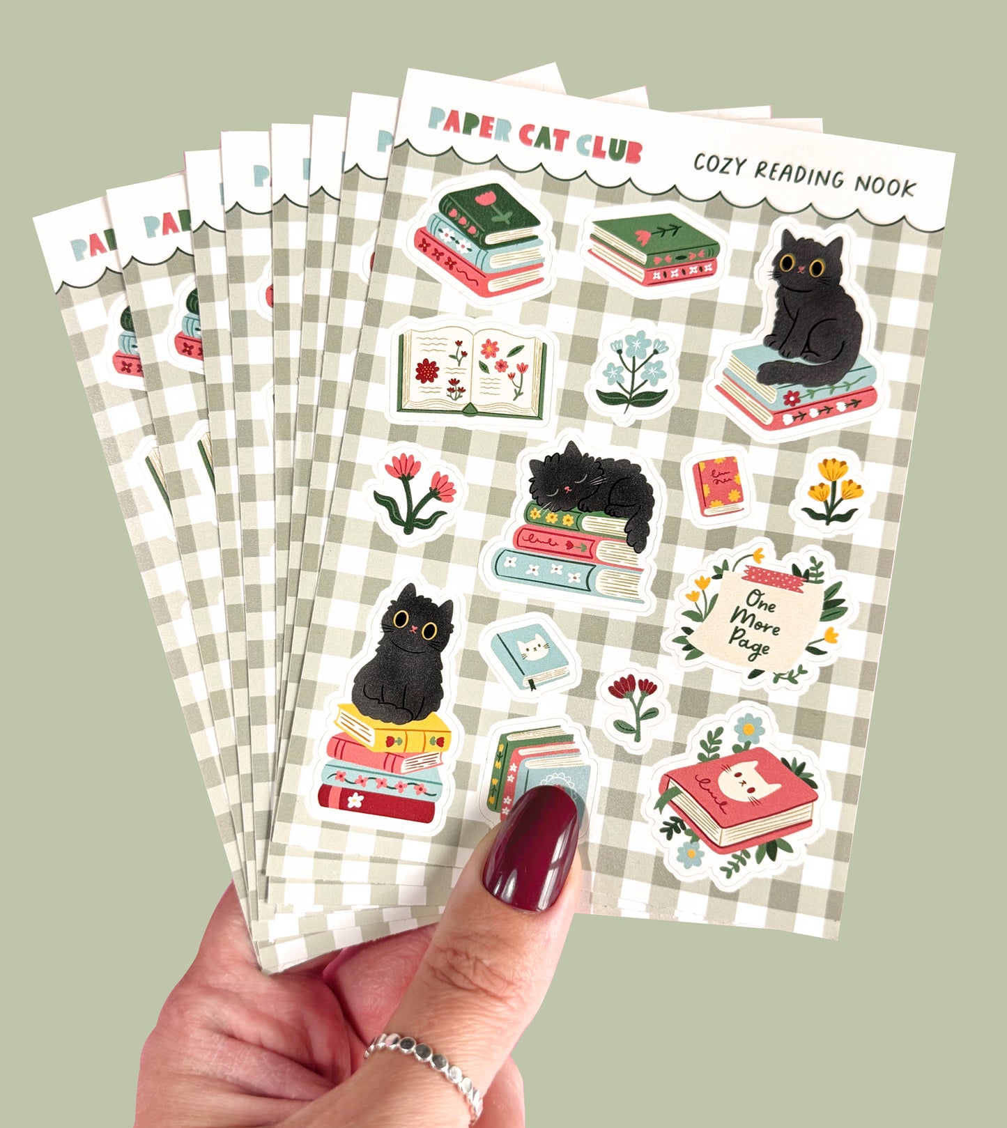 A6 sticker sheet featuring cute cats and books in a cozy, cottagecore-style setting.