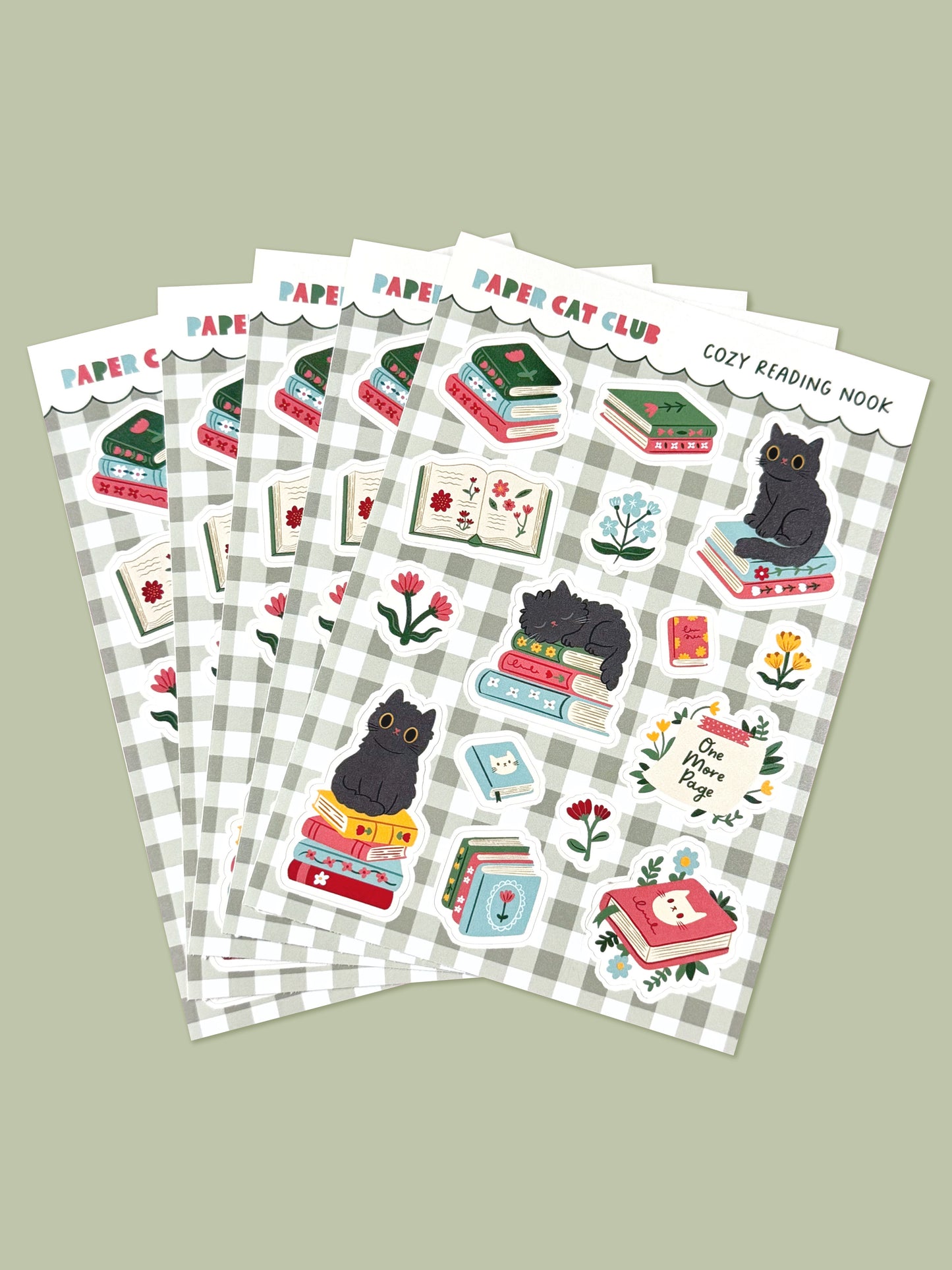 Set of sticker sheets with cat-themed bookish designs on a green gingham background.