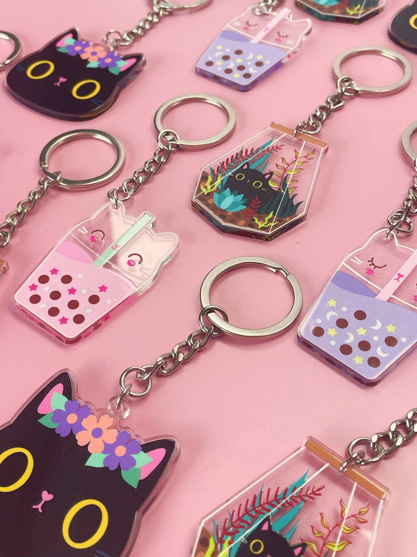 Collection of kawaii acrylic keyrings in various designs, featuring cute cats as bubble tea, perfect for fans of kawaii, cats, and bubble tea. Each keyring showcases a unique, double-sided design.