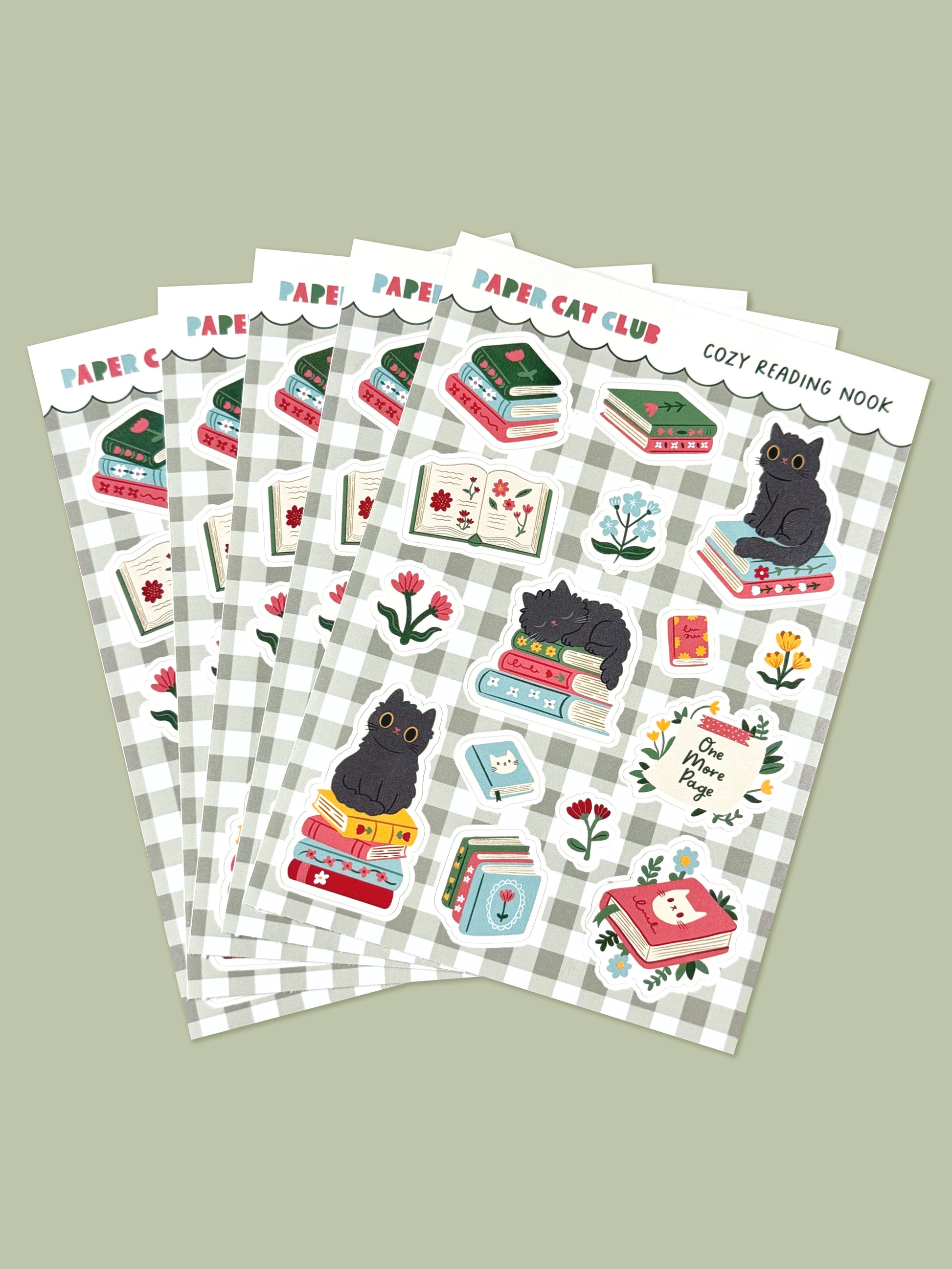 Set of sticker sheets with cat-themed bookish designs on a green gingham background.