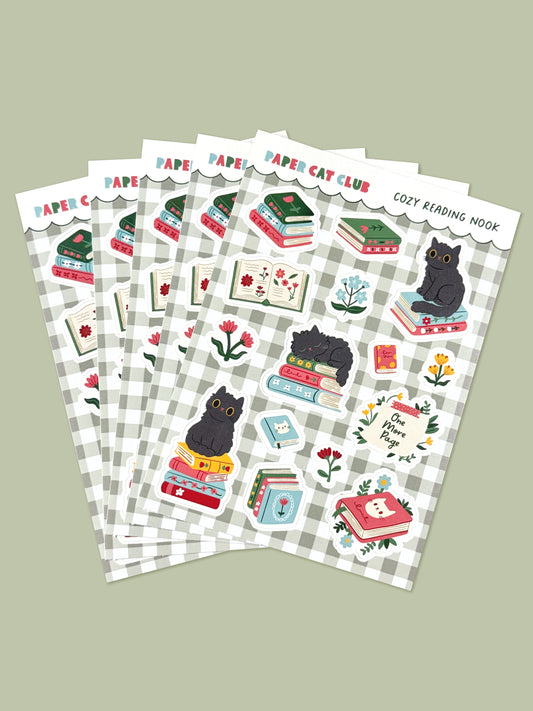 Set of sticker sheets with cat-themed bookish designs on a green gingham background.