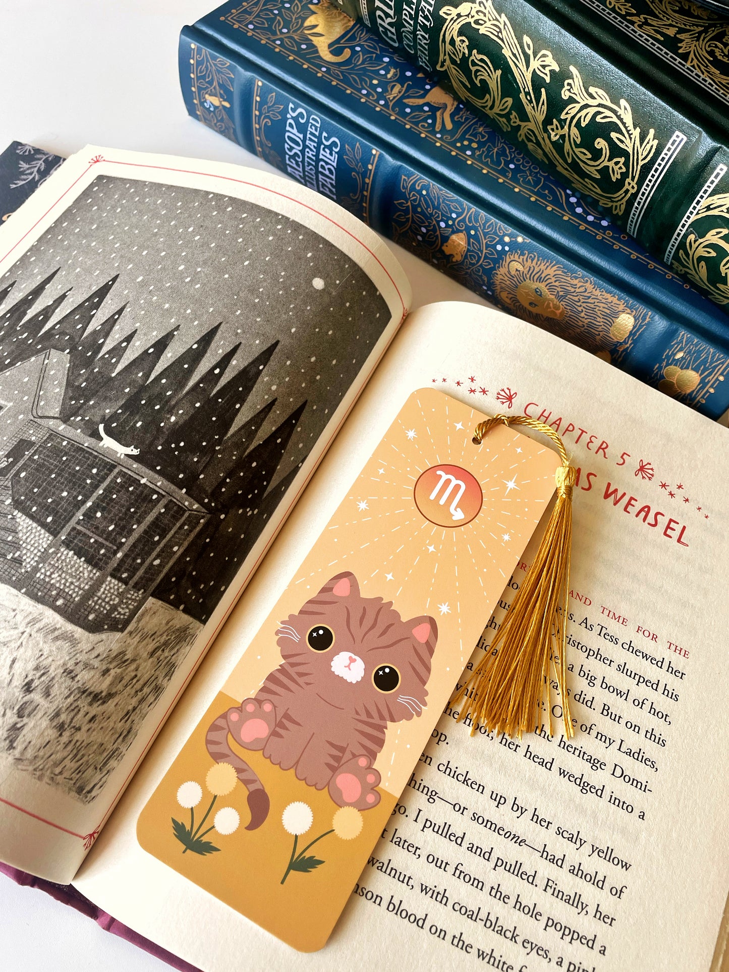 Scorpio astrology bookmark - cute cat illustrated bookmark with golden tassle pictured inside a book