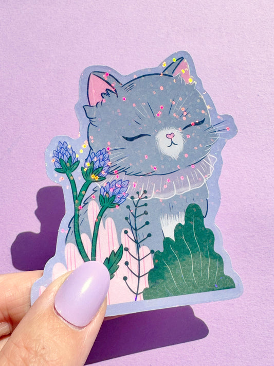 A cute, small vinyl sticker featuring a serene grey cat, depicted in a kawaii style with closed eyes, conveying a sense of calm and peace. This calming cat decal is ideal for personalizing laptops, notebooks, and water bottles, and would make a lovely, tranquil gift for cat lovers in the UK.