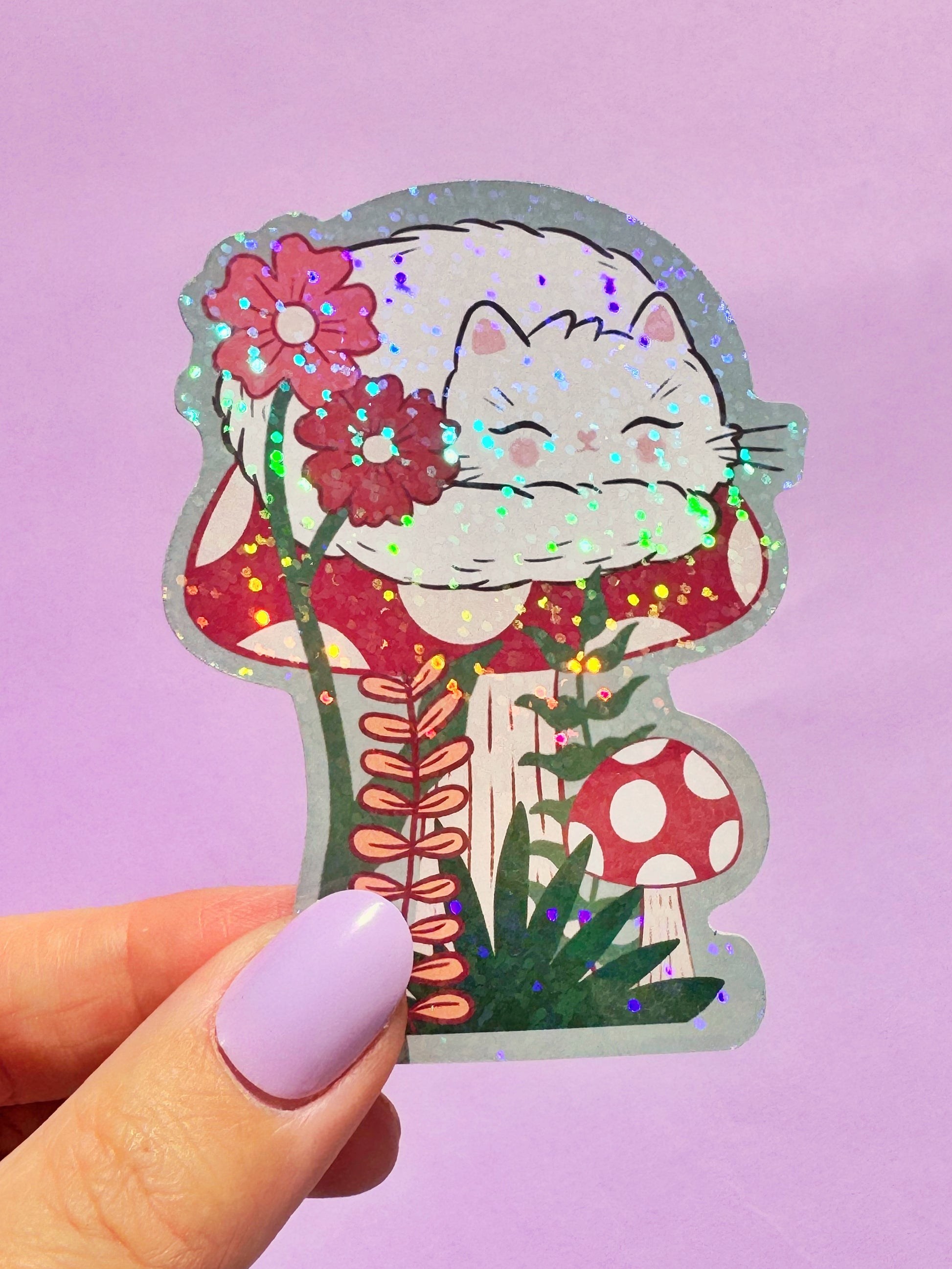 Adorable holographic sticker of a sleeping white cat in a cute kawaii style. This sparkly decal is a popular choice for teens, students, and anyone who loves cute animal stickers and wants to add a touch of shimmer to their belongings like laptops, water bottles, and notebooks. A great small gift for cat enthusiasts.