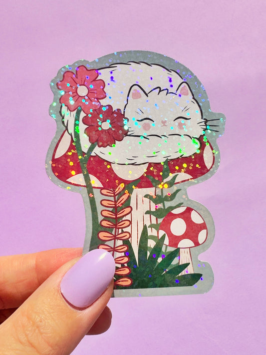 Adorable holographic sticker of a sleeping white cat in a cute kawaii style. This sparkly decal is a popular choice for teens, students, and anyone who loves cute animal stickers and wants to add a touch of shimmer to their belongings like laptops, water bottles, and notebooks. A great small gift for cat enthusiasts.