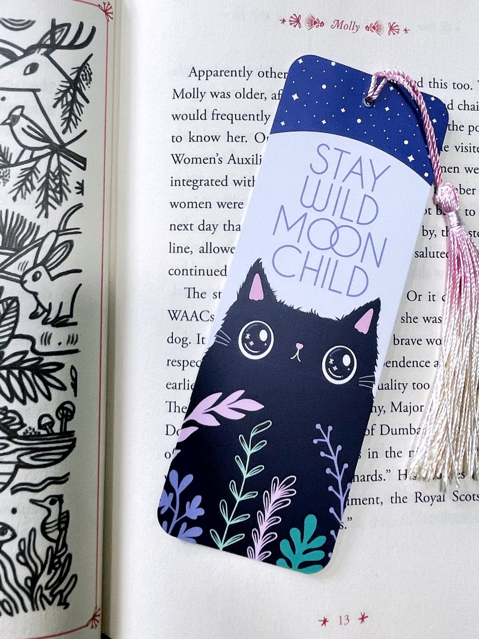 Cute whimsical cat bookmark with an ombre tassel and 'Stay Wild, Moon Child' design. A perfect gift for cat lovers, bookworms, and fans of magical aesthetics.